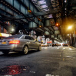 NYC subway tracks above street in Brooklyn.