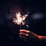 Hand holding sparkler - File Photo