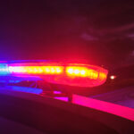 Police car with emergency lights at night.