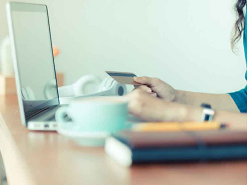 Cyber-Monday-sale-tag-banner-with-woman-holding-credit-card-use-laptop-computer-to-shopping-online-at-cafe