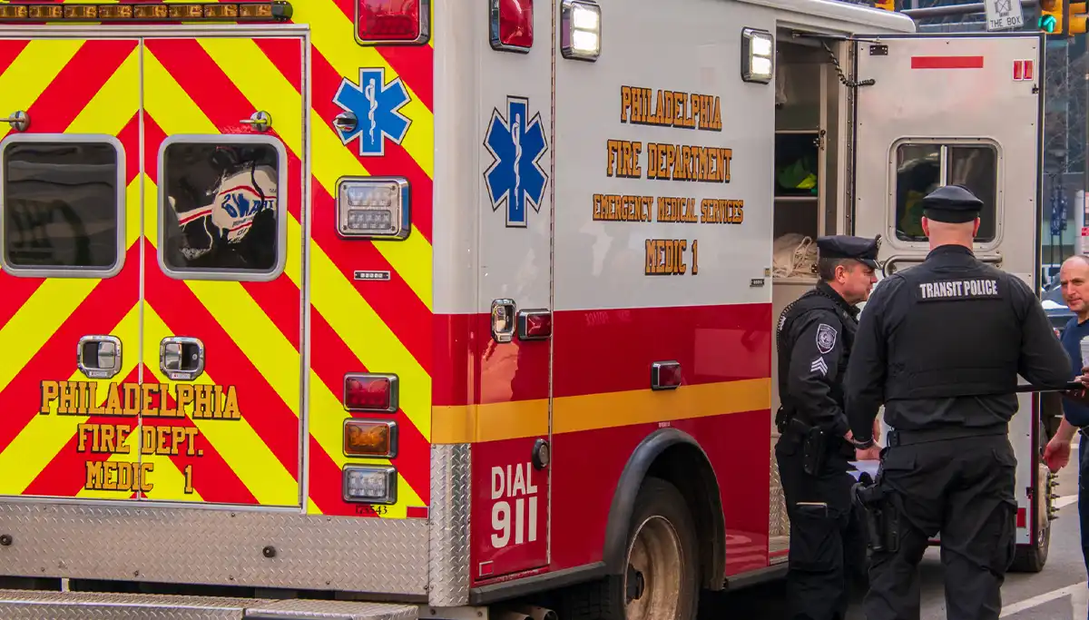 Two Philadelphia Transit Policeman are seen by a Philadelphia Fire Department Emergency Medical Services ambulance on a city street